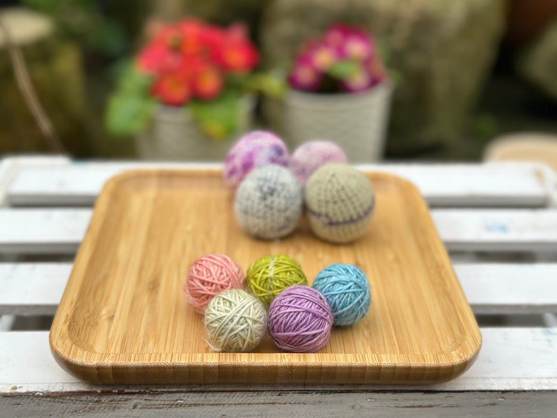 Five tiny balls of yarn in floral colours