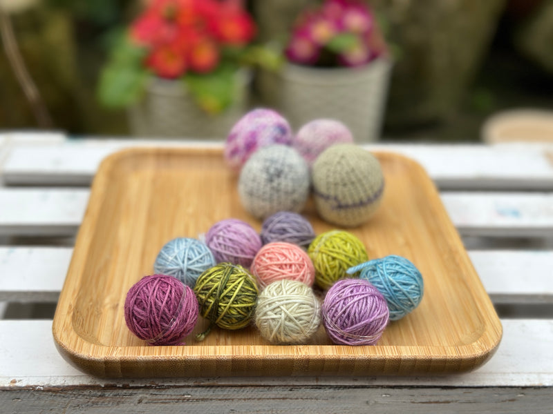 Ten tiny balls of yarn in floral colours
