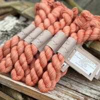 A pile of mini skeins of orange yarn