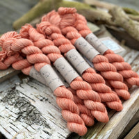 A pile of mini skeins of orange yarn