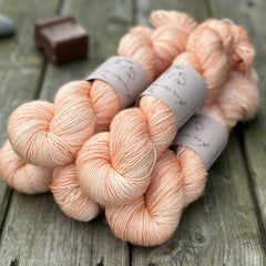 Five skeins of pale orange yarn