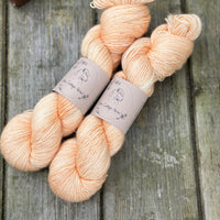 Two skeins of light orange yarn