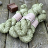 Four skeins of green yarn