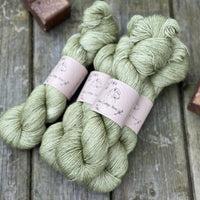 Four skeins of green yarn