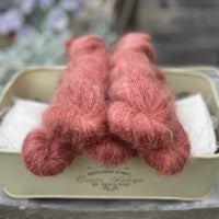 Five skeins of red fluffy yarn