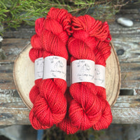 Five skeins of bright red yarn