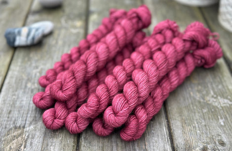 Reddish-purple mini skeins of yarn