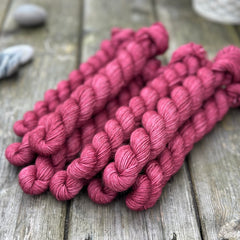 Reddish-purple mini skeins of yarn