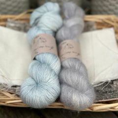 Two skeins of yarn - one pale blue and one fluffy grey