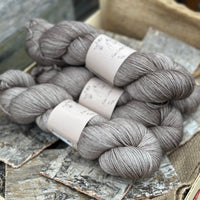 Four skeins of yarn in light brown