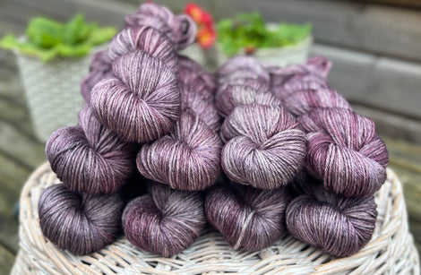 Skeins of variegated grey and purple yarn