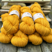 Seven skeins of rich yellow yarn