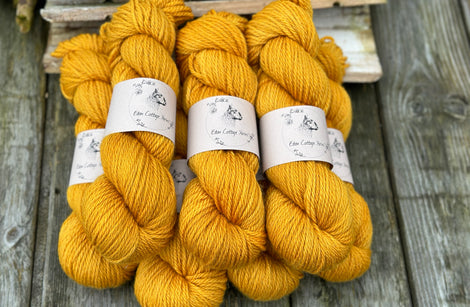 Seven skeins of rich yellow yarn