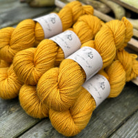 Seven skeins of rich yellow yarn