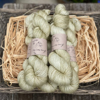 Five skeins of light brownish green yarn
