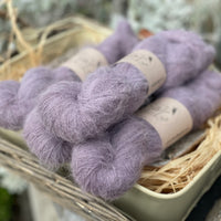 Four skeins of purple fluffy yarn