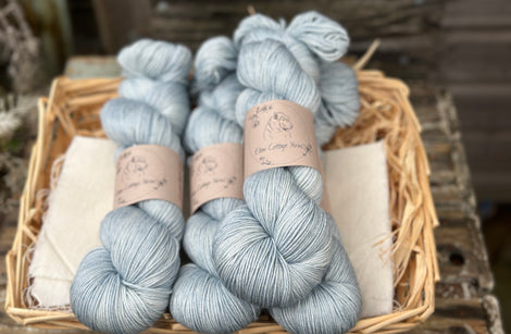Four skeins of pale blue yarn