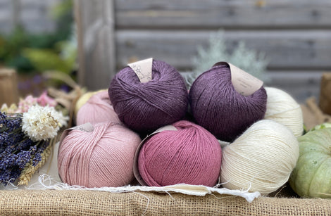 Eight balls of Milburn 4ply in shades of pink, purple and cream