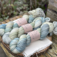Three skeins of variegated blue and green yarn