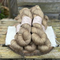 Five skeins of yellowy brown yarn