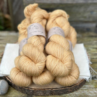 Five skeins of golden yellow yarn