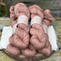 Five skeins of brownish pink yarn