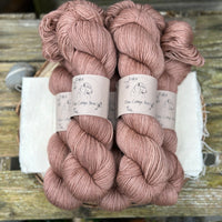 Five skeins of brownish pink yarn