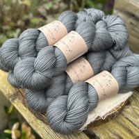 Six skeins of blue grey yarn