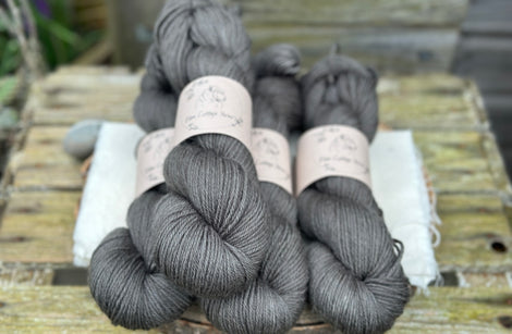 Four skeins of dark grey yarn