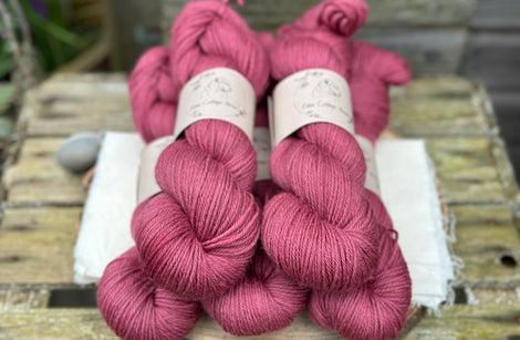 Five skeins of purpley red yarn