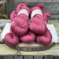 Five skeins of purpley red yarn