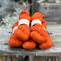 Five skeins of dark orange yarn