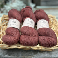 Three skeins of reddish brown yarn
