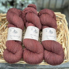 Three skeins of reddish brown yarn