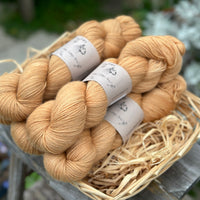Five skeins of golden brown yarn