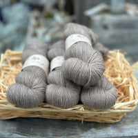 Four skeins of grey-brown yarn