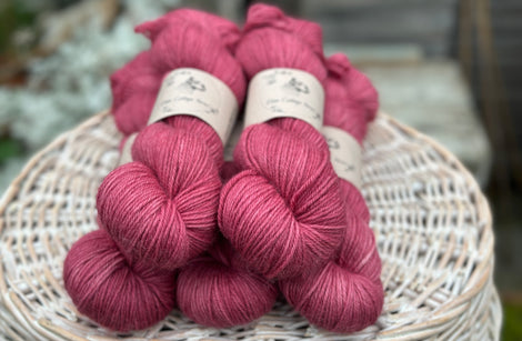 Five skeins of pinky red yarn