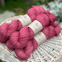 Five skeins of pinky red yarn