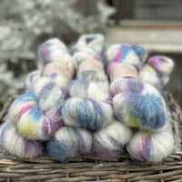 Multicoloured fluffy yarn on an upturned wicker basket.