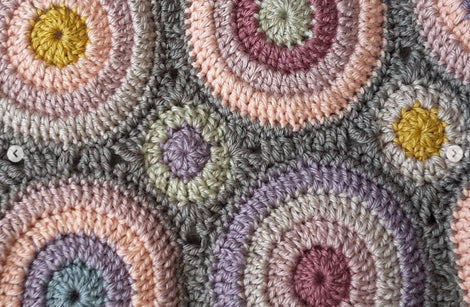 Close up image of circular motifs and colour combinations of a crochet wrap