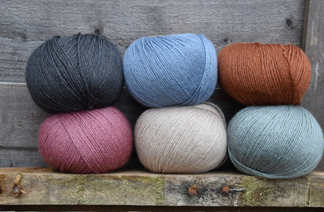 Six balls of Milburn 4ply in black, blue, beige, rust and pink