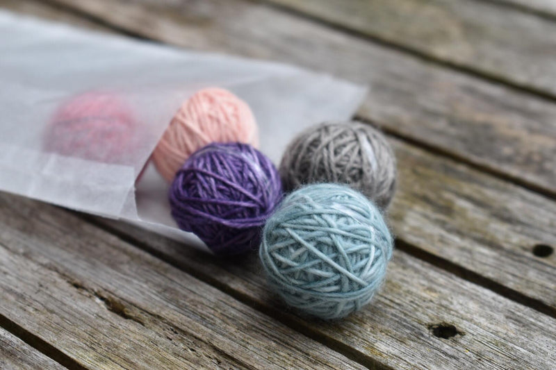 Five Yarnlings spilling out of a glassine bag