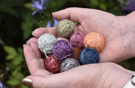 A pair of hands holding a selection of Yarnlings