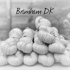 Black and white image of skeins of yarn with "Brimham DK" overlaid in black text