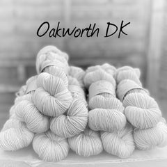 Black and white image of skeins of yarn with "Oakworth DK" overlaid in black text
