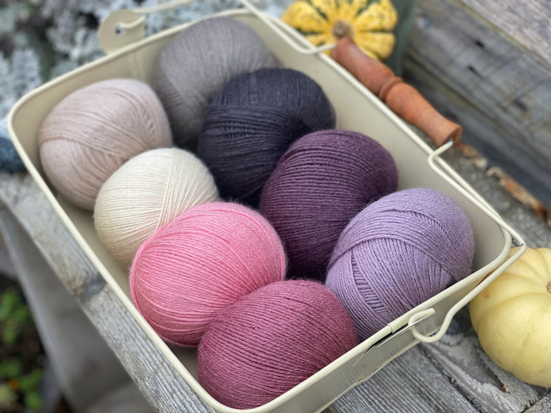 Eight balls of Milburn 4ply in shades of pink, grey and purple