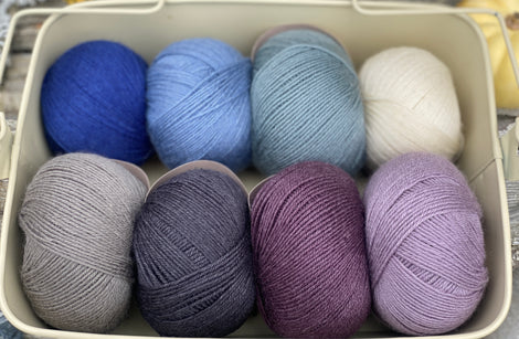 Eight balls of Milburn 4ply in shades of blue and purple