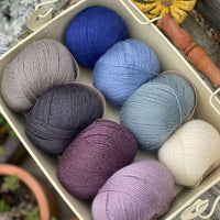 Eight balls of Milburn 4ply in shades of blue and purple