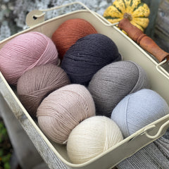 Eight balls of Milburn 4ply in shades of brown, grey and red