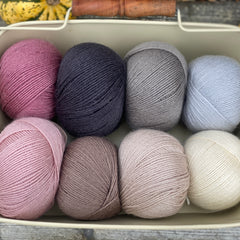 Eight balls of Milburn 4ply in shades of pink, brown and grey